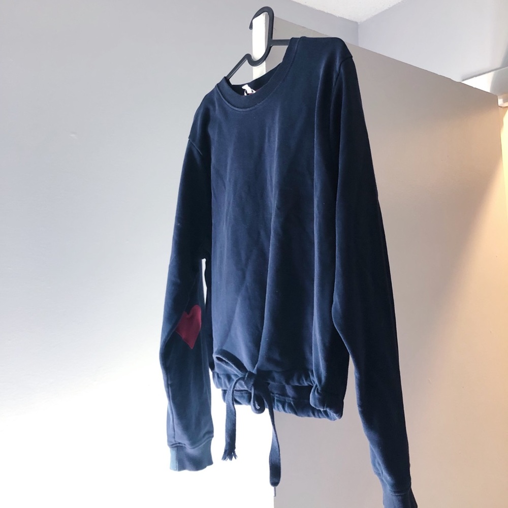 I’m selling this cute sweater with hearts on the elbows. from a cute shop in Lnd